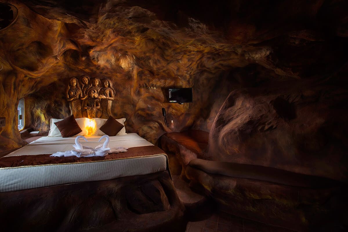 Luxury cave room with stone walls, warm lighting, and cozy interiors