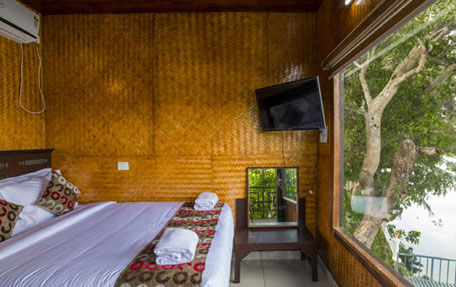 Air-conditioned tree house room at Warmth Lake Haven overlooking lush backwaters in Alleppey