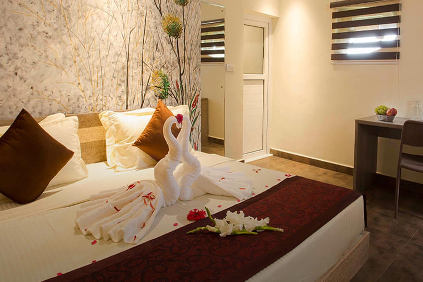 “Spacious deluxe room at Foggy Knolls Resort with modern interiors, cozy bedding, and panoramic Vagamon hill views.”