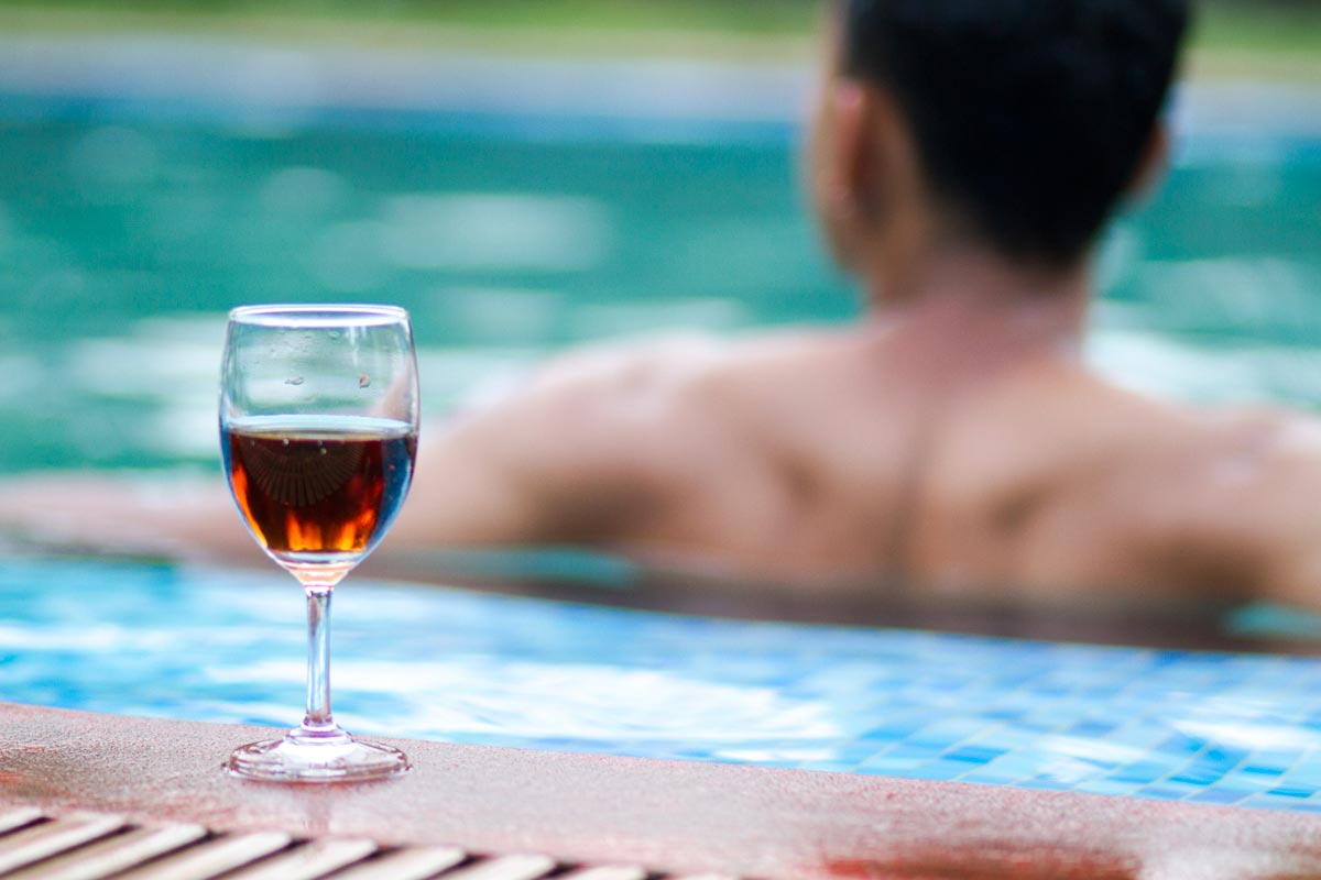 Open-air swimming pool at Misty Woods Resort Coorg surrounded by lush greenery and peaceful hillside views