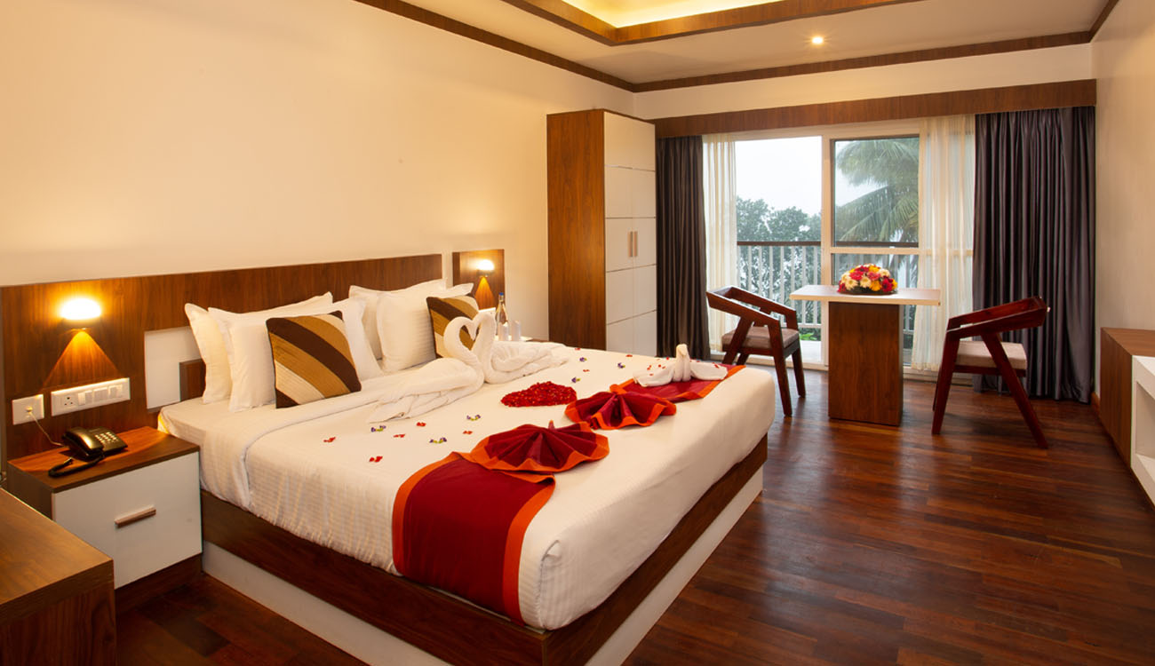 Luxury bedroom inside Cruise Land houseboat package with backwater views in Alleppey