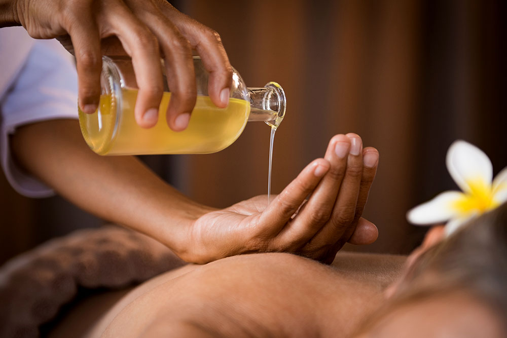 Traditional Ayurvedic oil bath therapy in Kochi using warm herbal medicated oils for relaxation and healing