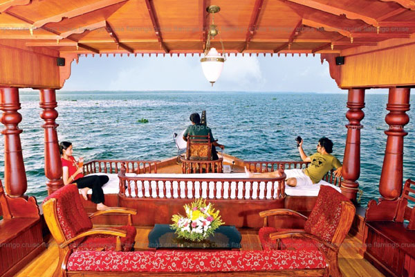 Romantic honeymoon couple enjoying a luxury houseboat cruise in the serene Kerala Alleppey backwaters