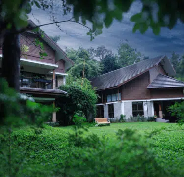 Luxury hill resort Morickap Resort in Wayanad surrounded by lush greenery and misty mountains offering premium villas, swimming pool, and scenic nature views.