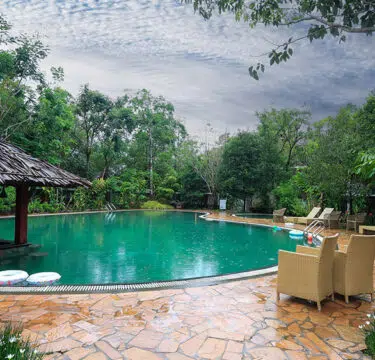 Luxury 3250 sq. ft. swimming pool at Morickap Resort in Wayanad surrounded by lush green hills and scenic mountain views, ideal for relaxation and family leisure.