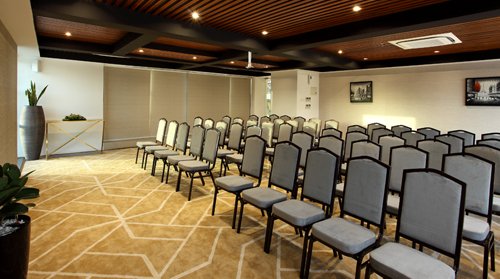 Corporate conference hall setup at Sugar Business Hotel Kochi with modern interiors and executive seating