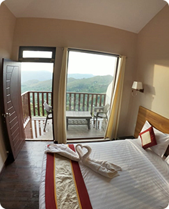 Comfortable and spacious rooms at Warmth Hill Crest, Kodaikanal, featuring modern amenities, cozy interiors, and beautiful valley views for a relaxing stay.