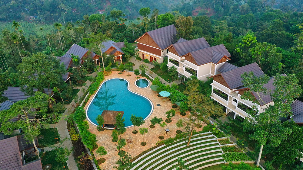Luxury Morickap Resort in Wayanad surrounded by misty mountains, lush greenery, and scenic Western Ghats landscape.