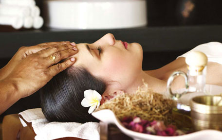 Guest enjoying an authentic Ayurveda wellness therapy at Warmth Lake Haven in Alleppey, surrounded by peaceful backwaters and natural greenery.