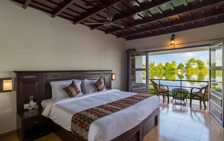 Comfortable stay at Warmth Lake Haven in Alleppey featuring elegant accommodations, serene backwater views, and a peaceful natural setting.